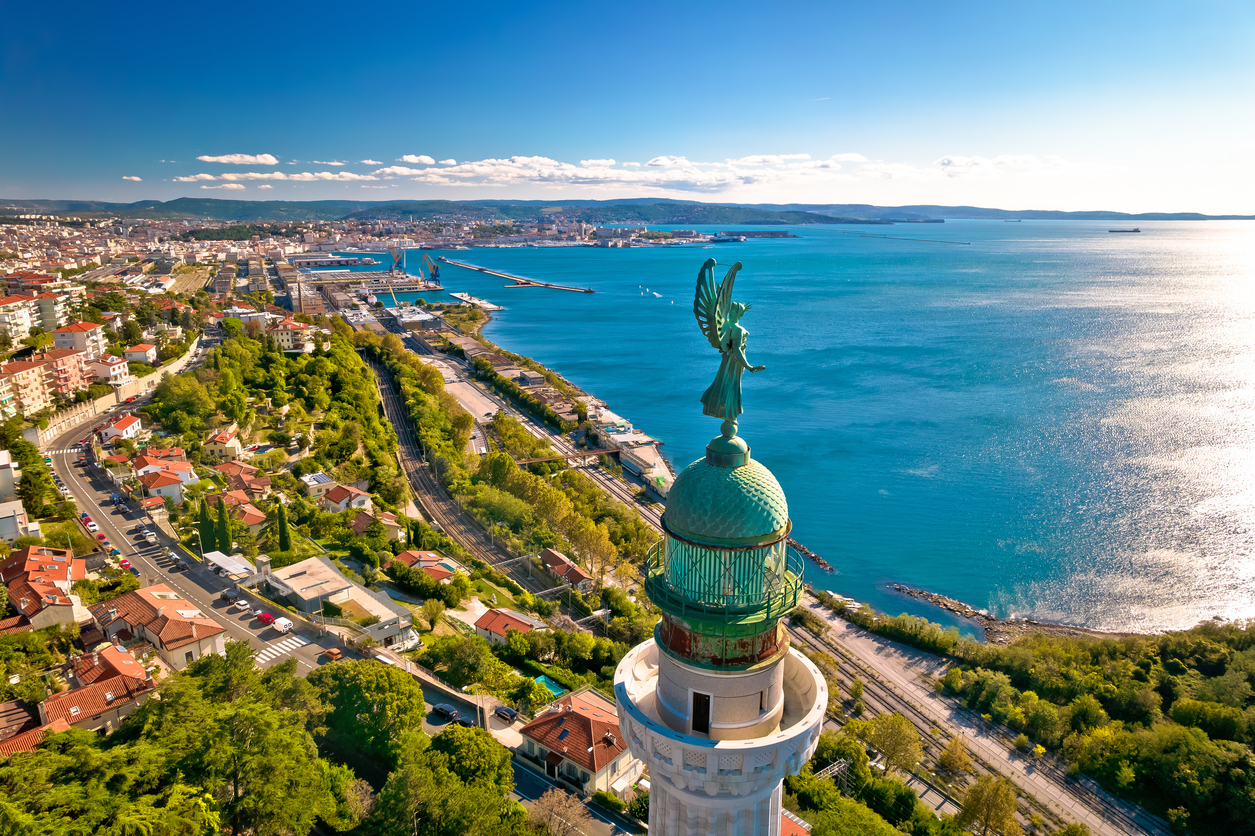 Faro della Vittoria vor dem Golf von Triest mit Stadt und Hafen im Hintergrund