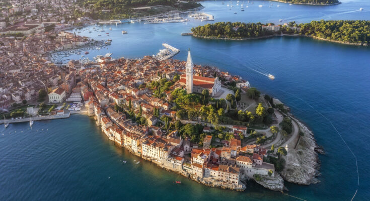 Luftbild von Rovinj mit Altstadt-Halbinsel und Kirche der Hl. Euphemia, umgeben von Adria, Marina und Segelbooten