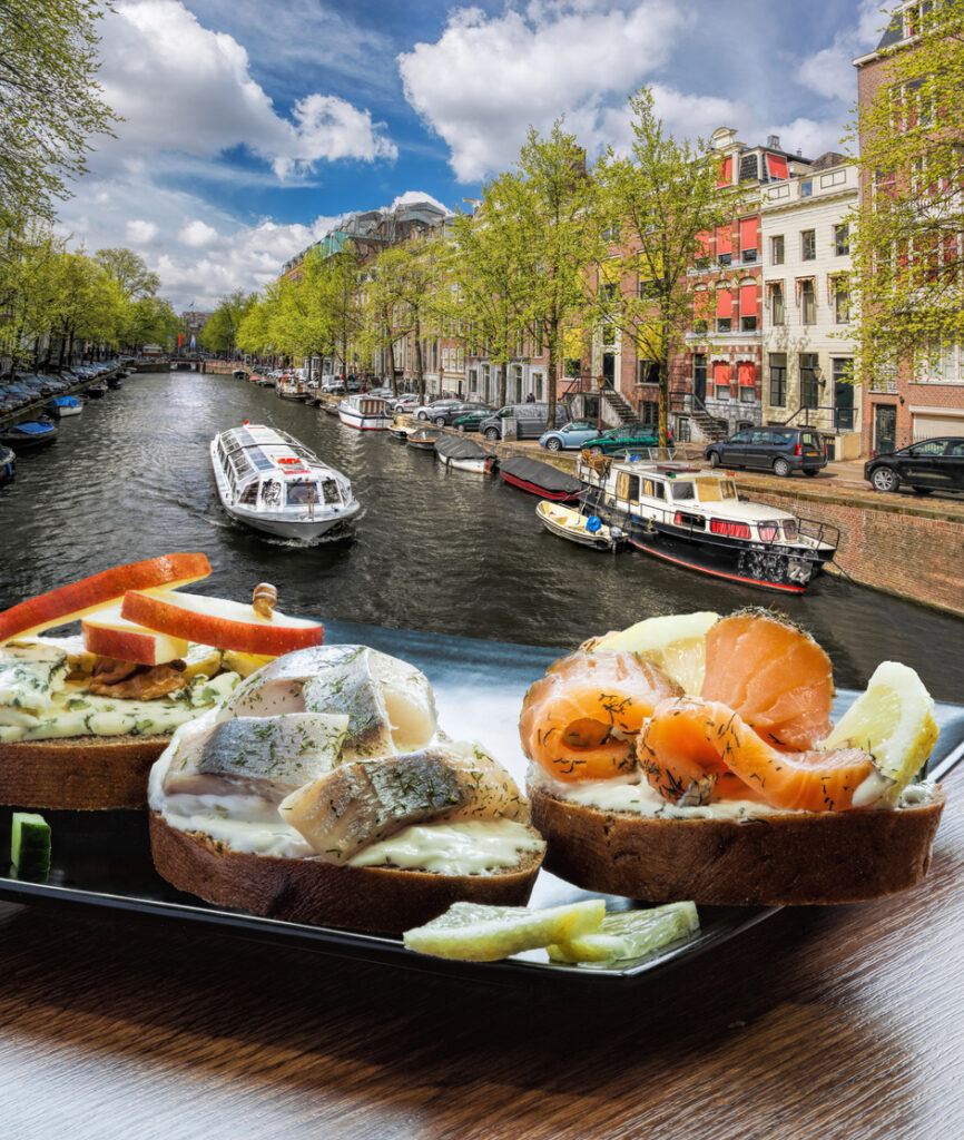 Dunkles Brot mit Lachs, Hering und Käse vor Amsterdamer Gracht