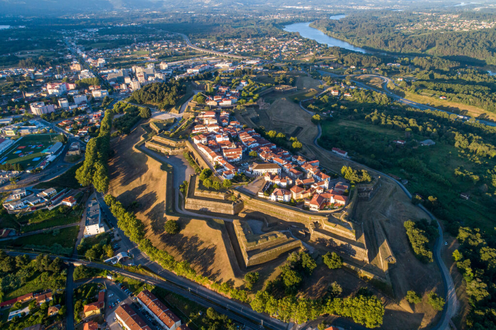 Aerial von Valença do Minho: sternförmige Festung mit Stadt innerhalb der Mauern, Grünflächen und Fluss.