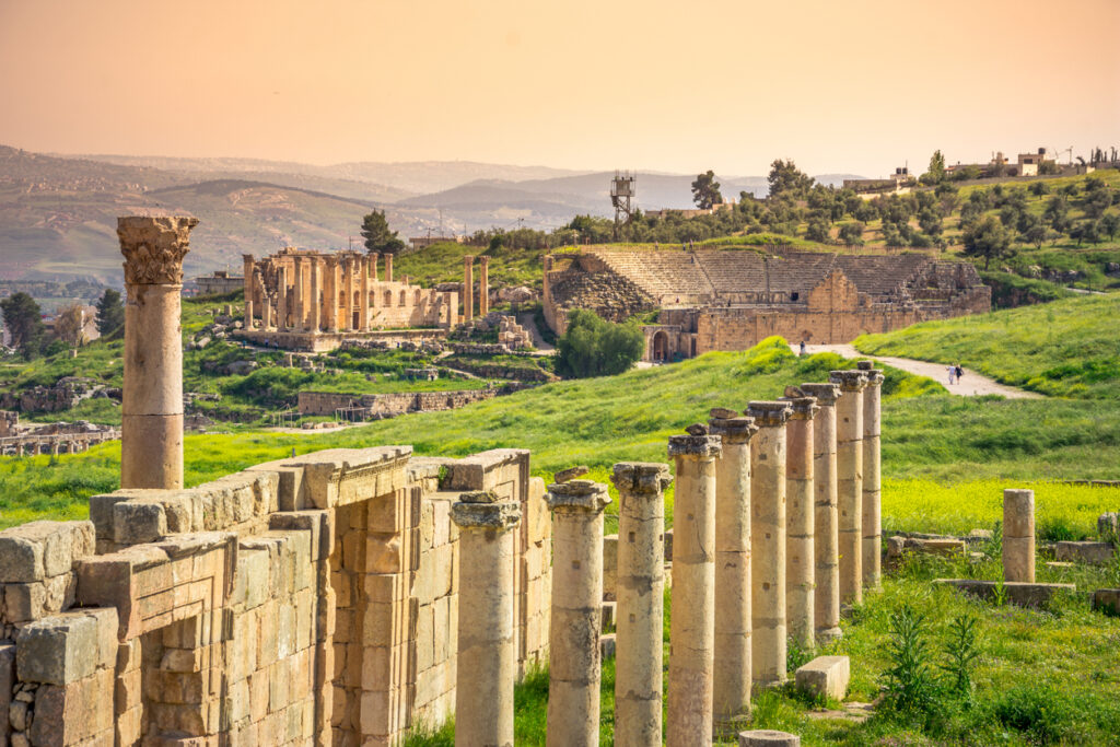 Antike Säulenstraße und Theater in Jerash bei warmem Abendlicht.