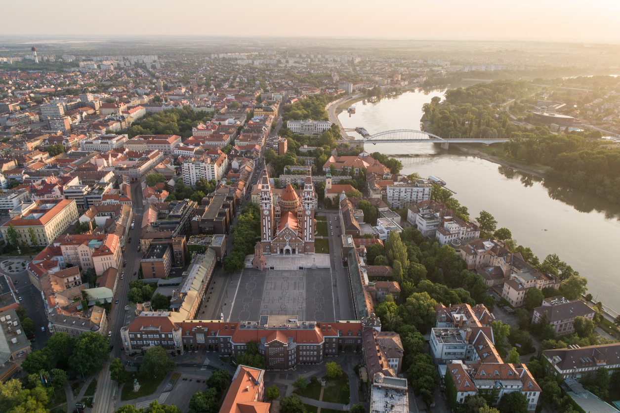 Luftaufnahme mit Votivkirche, Domplatz und Theißbrücke bei Sonnenuntergang