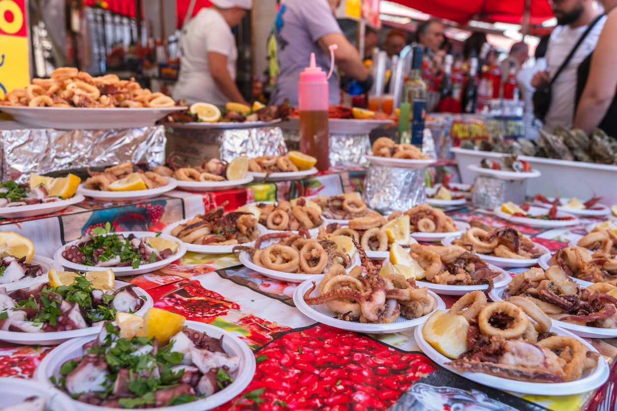 Teller mit frittiertem Fisch und Tintenfisch auf einem Straßenmarkt in Palermo.