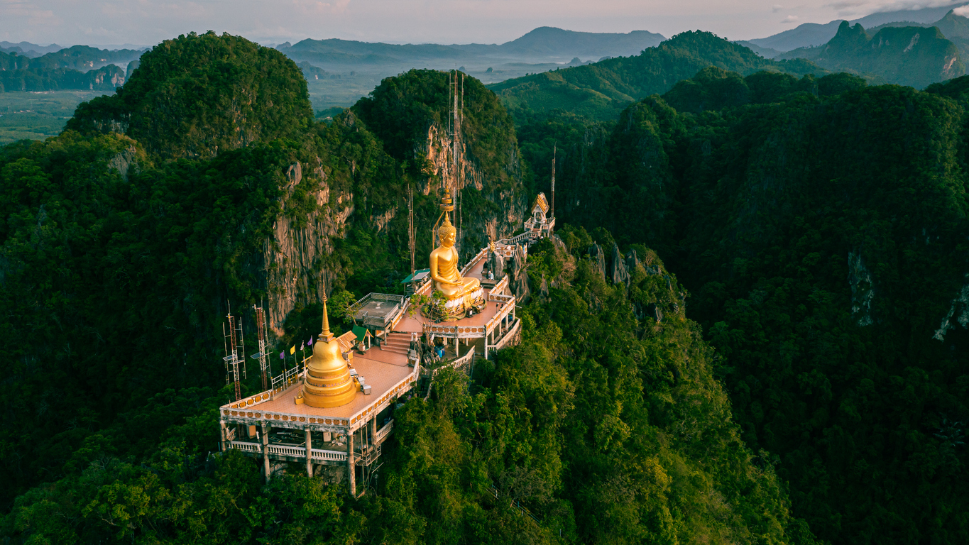 Luftaufnahme des auf einem Berggipfel thronenden Tiger-Tempels mit goldenem Buddha bei Krabi in Thailand.