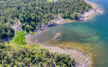 Luftaufnahme einer felsigen Küste mit Wald und klaren Buchten im Bottnischen Meerbusen.