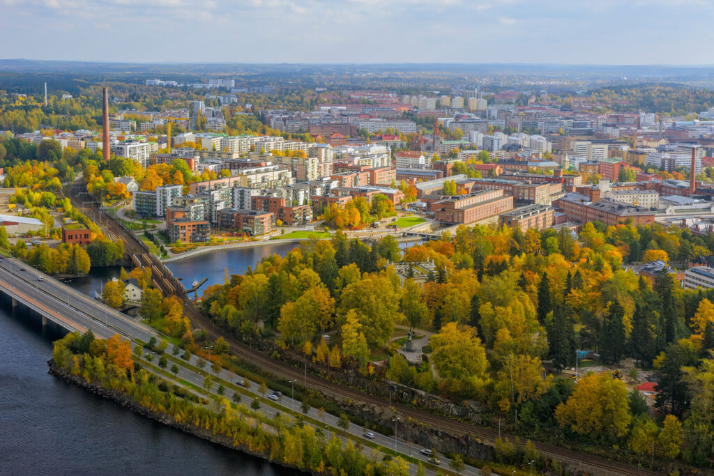 Luftaufnahme von Tampere mit Seen, Brücken und bunten Herbstbäumen.