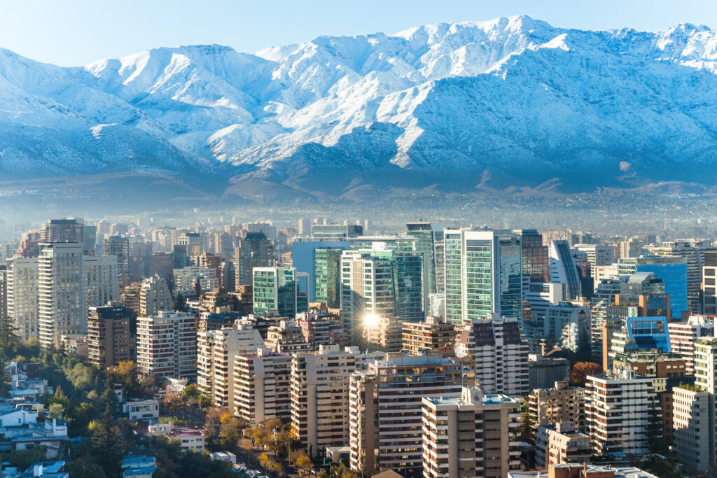 Moderne Glasfassaden prägen die Skyline von Santiago, Chile, vor den schneebedeckten Anden.