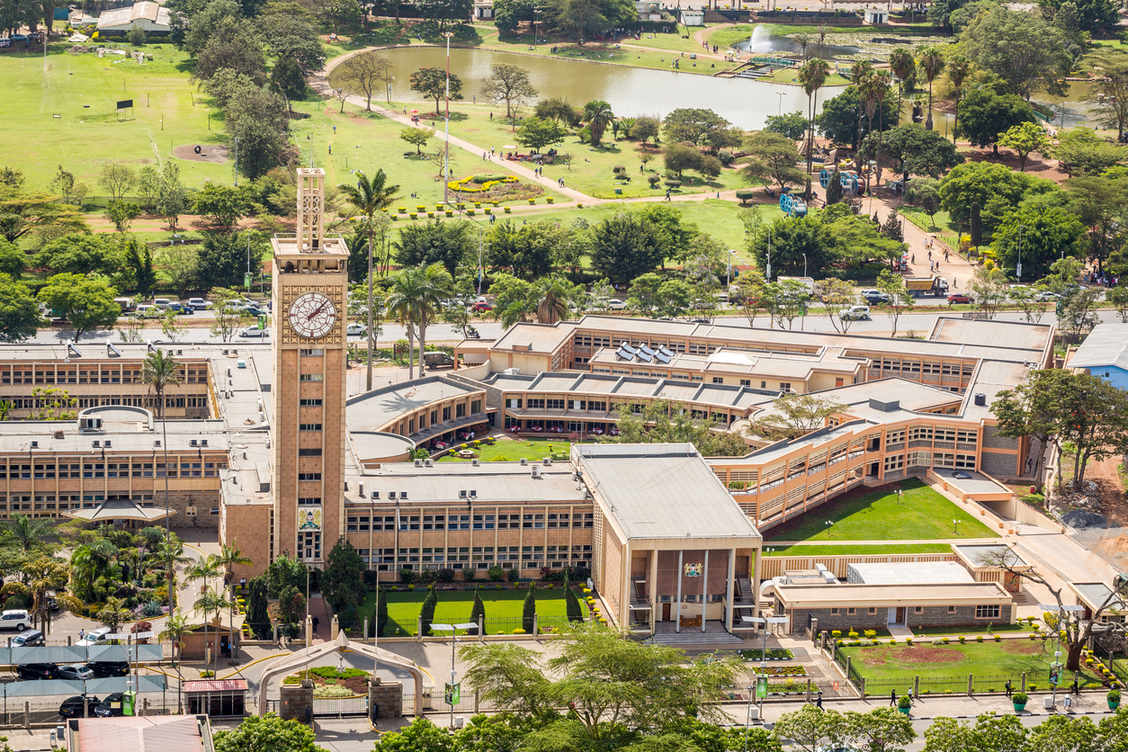 Luftaufnahme des Parlaments in Nairobi mit Uhrenturm und angrenzendem Park mit See.